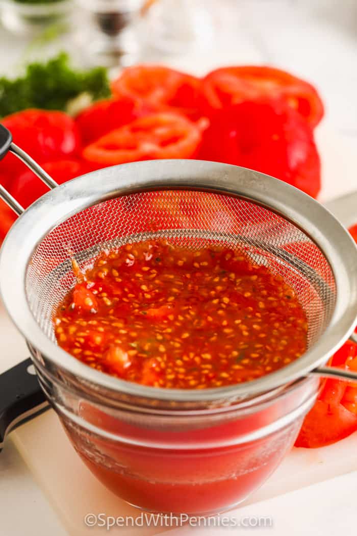 Drain the tomato seeds into a bowl to make fresh tomato sauce