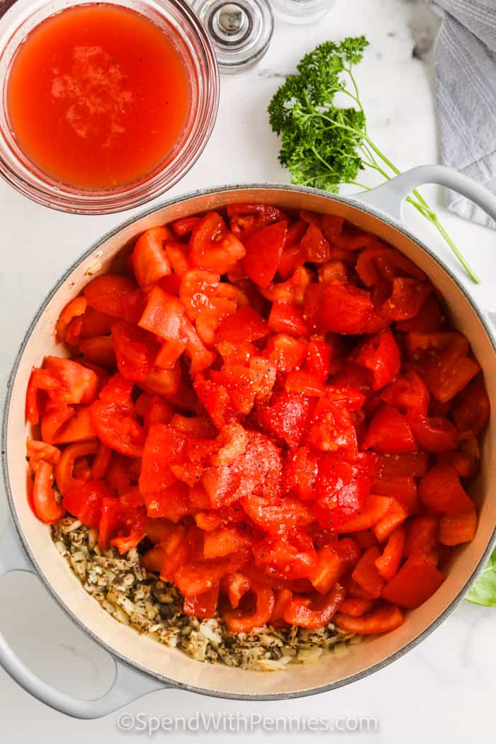 adding tomatoes and seasonings to the onions in the pan to make fresh tomato sauce