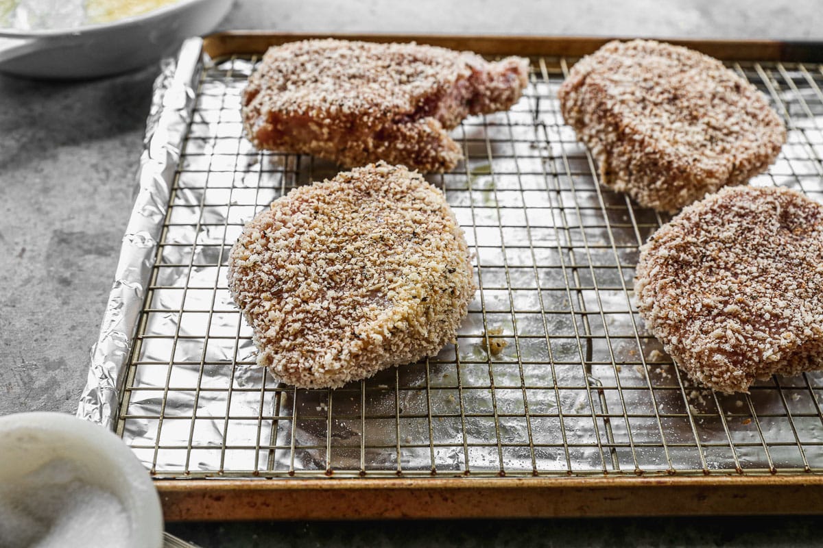 Breaded pork chops baked in the oven on a baking sheet