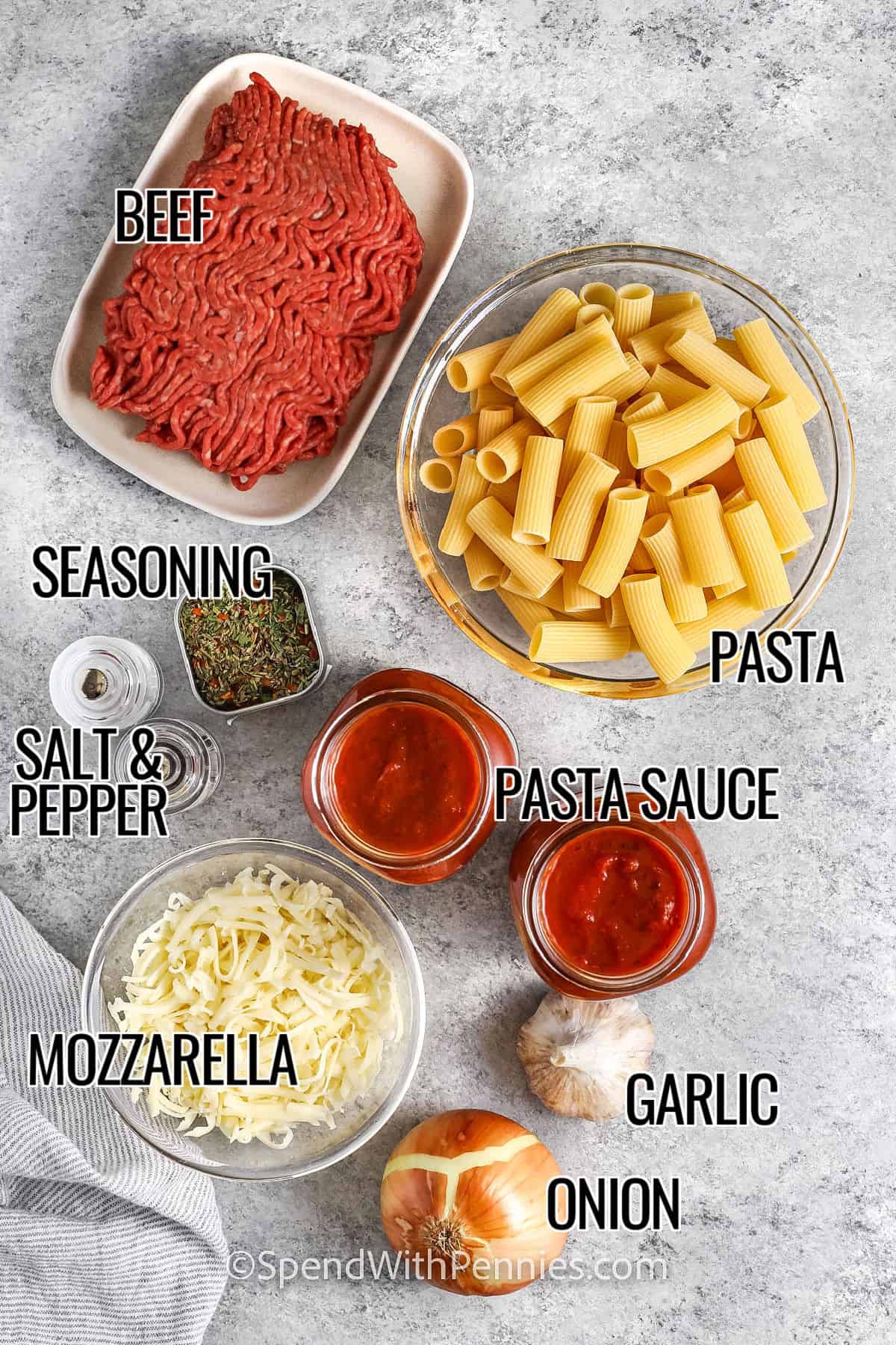 Beef, pasta, seasonings, pasta sauce, garlic, onion, mozzarella cheese, salt and pepper with labels to make Baked Rigatoni