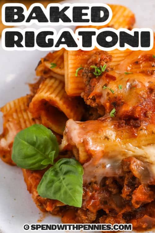 Baked rigatoni with meat sauce on a plate with title