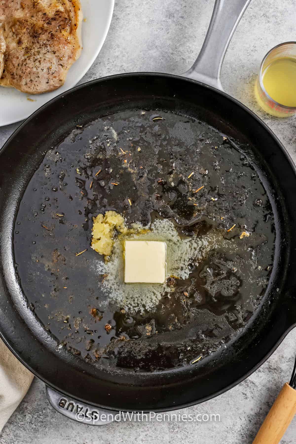 Garlic and butter with seasonings in the pan to make pork steak