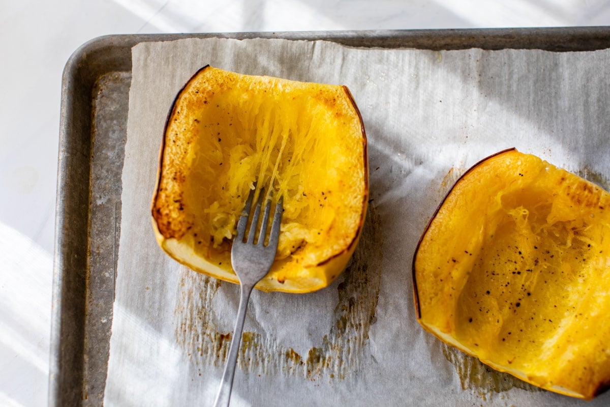 Shred roasted spaghetti squash with a fork