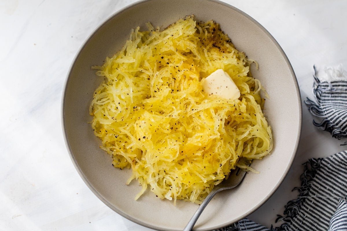 Roasted spaghetti squash in a bowl with butter