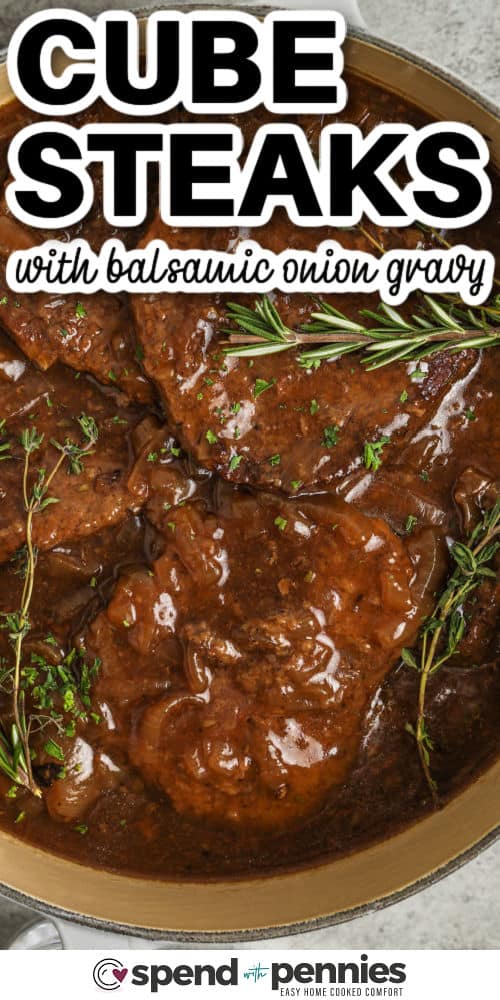 Tasty cube steaks with balsamic onion sauce in a pot with title