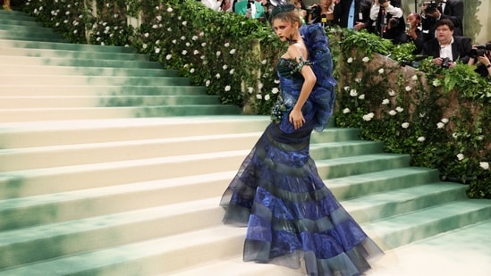 Zendaya's first look for the 2024 Met Gala was equally stunning: a corset gown covered in iridescent electric blue organza, hand-painted metallic horsehair and a curtain of foil material with a bow. (REUTERS)