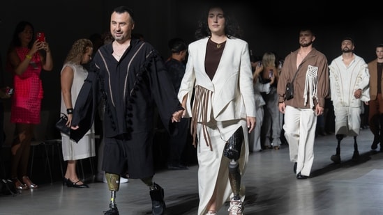 Ukrainian war veterans with prosthetic limbs walk the catwalk to showcase outfits by designers Andreas Moskin and Andriy Bilous during the Fashion Week show. (AP Photo/Efrem Lukatsky)