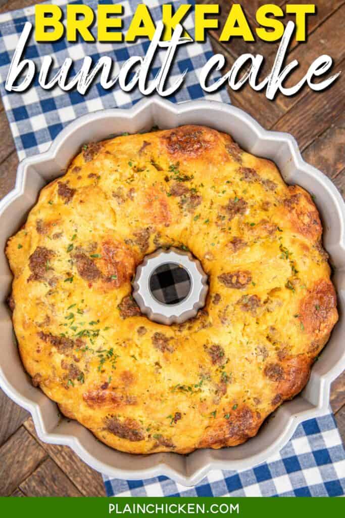 Breakfast casserole with sausage and biscuits in a Bundt cake pan on a table with a blue checkered tablecloth with text overlay