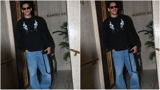 Vijay Varma's latest look is super stylish - he sports a black sweatshirt adorned with a chic floral print. Paired with baggy jeans and black sunglasses, he looked effortlessly chic. (HT Photo/VarinderChawla)