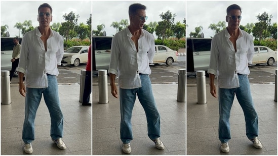 Akshay Kumar made a stylish appearance at the airport in an effortlessly casual look. He wore a white button-down shirt, one side casually tucked into his baggy blue jeans. Paired with white sneakers and blue-tinted aviator sunglasses, he looked undeniably stylish. (HT Photo/VarinderChawla)