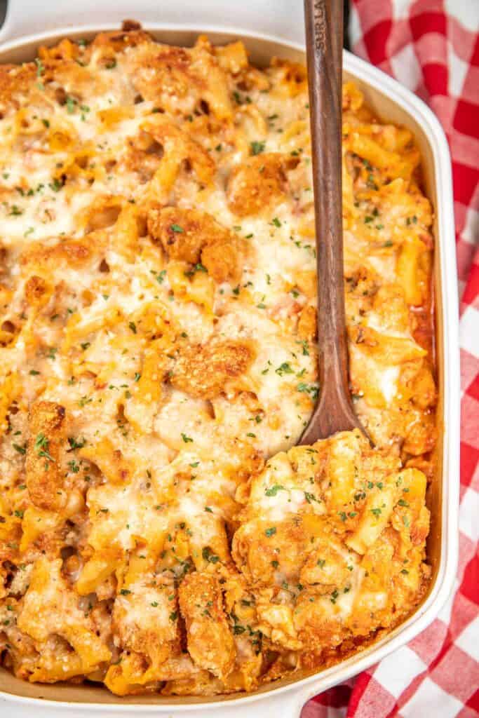 Remove the chicken parmesan pasta casserole from a baking dish