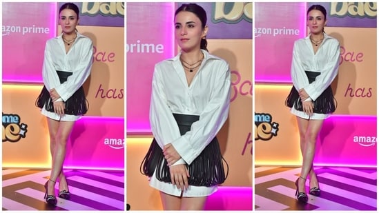 Radhika Madan looked stunning in a white shirt dress paired with a black fringed miniskirt for a stylish touch. She completed her look with stacked necklaces, stud earrings, high heels and her hair was styled in a sleek ponytail. (HT Photo/VarinderChawla)