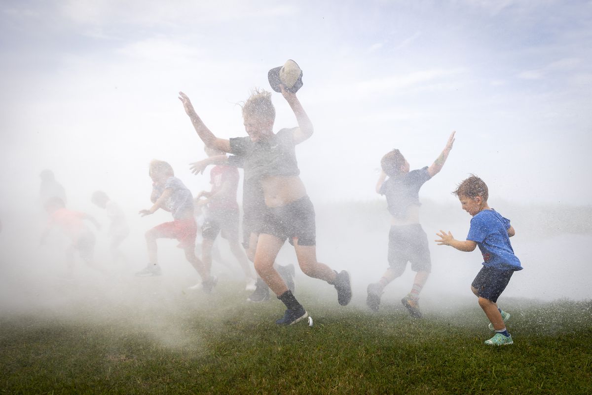 Children are sprayed with water from airboats at the Texas Gatorfest in Anahuac.