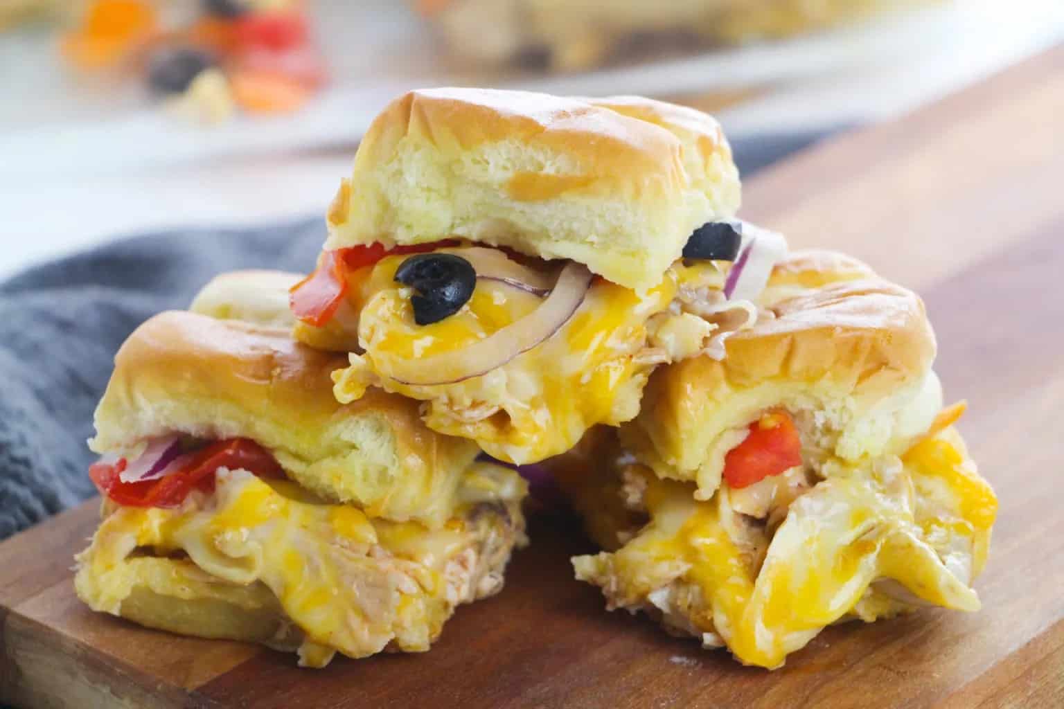 Stack of sliders on a wooden board.