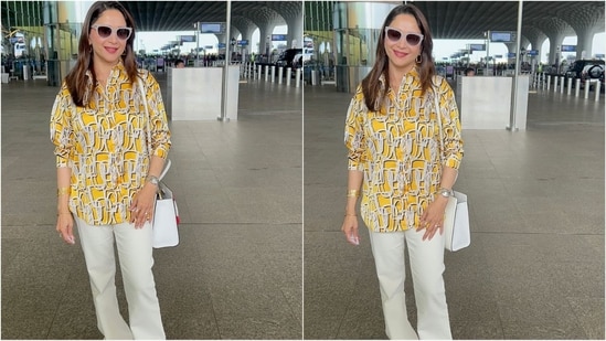 Madhuri Dixit's latest airport look is a perfect blend of comfort and style. She wore a yellow collared kurti, paired with white trousers for a chic yet casual look. She accessorized her outfit with a white shoulder bag, a wristwatch and a pair of stylish sunglasses, adding a touch of style to her travel look. (HT Photo/VarinderChawla)