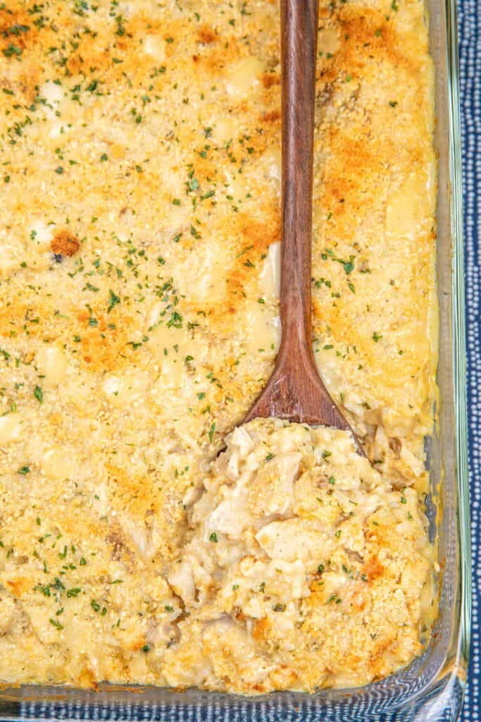 removing chicken and rice from a baking dish