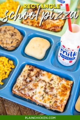 Lunch tray with rectangular pizza, milk, corn and a bun.