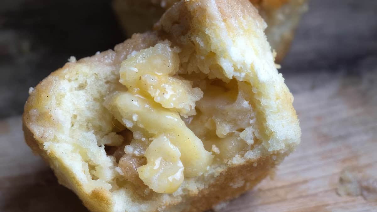 Apple Cheesecake Muffins with one muffin cut in half to show the center.