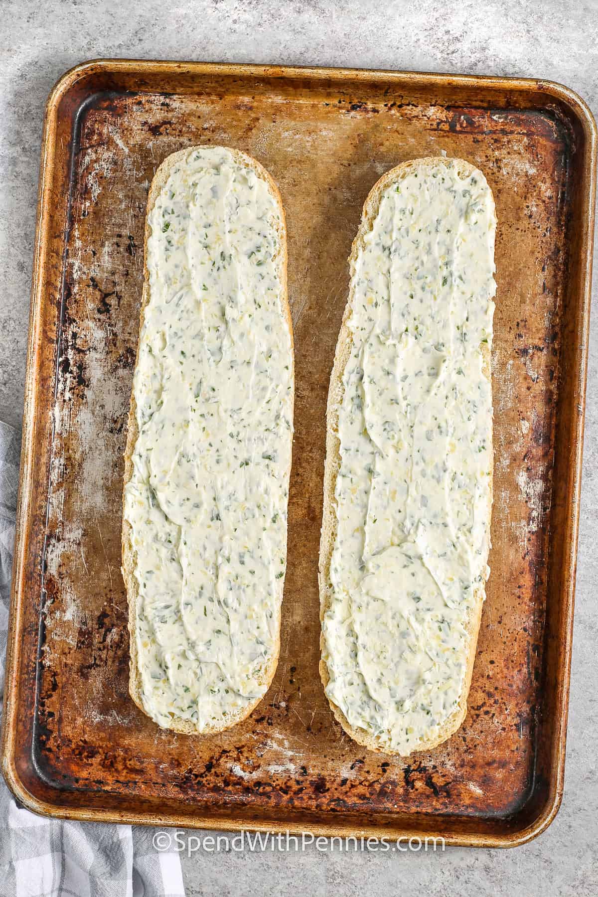 Add garlic butter to bread to make homemade garlic bread