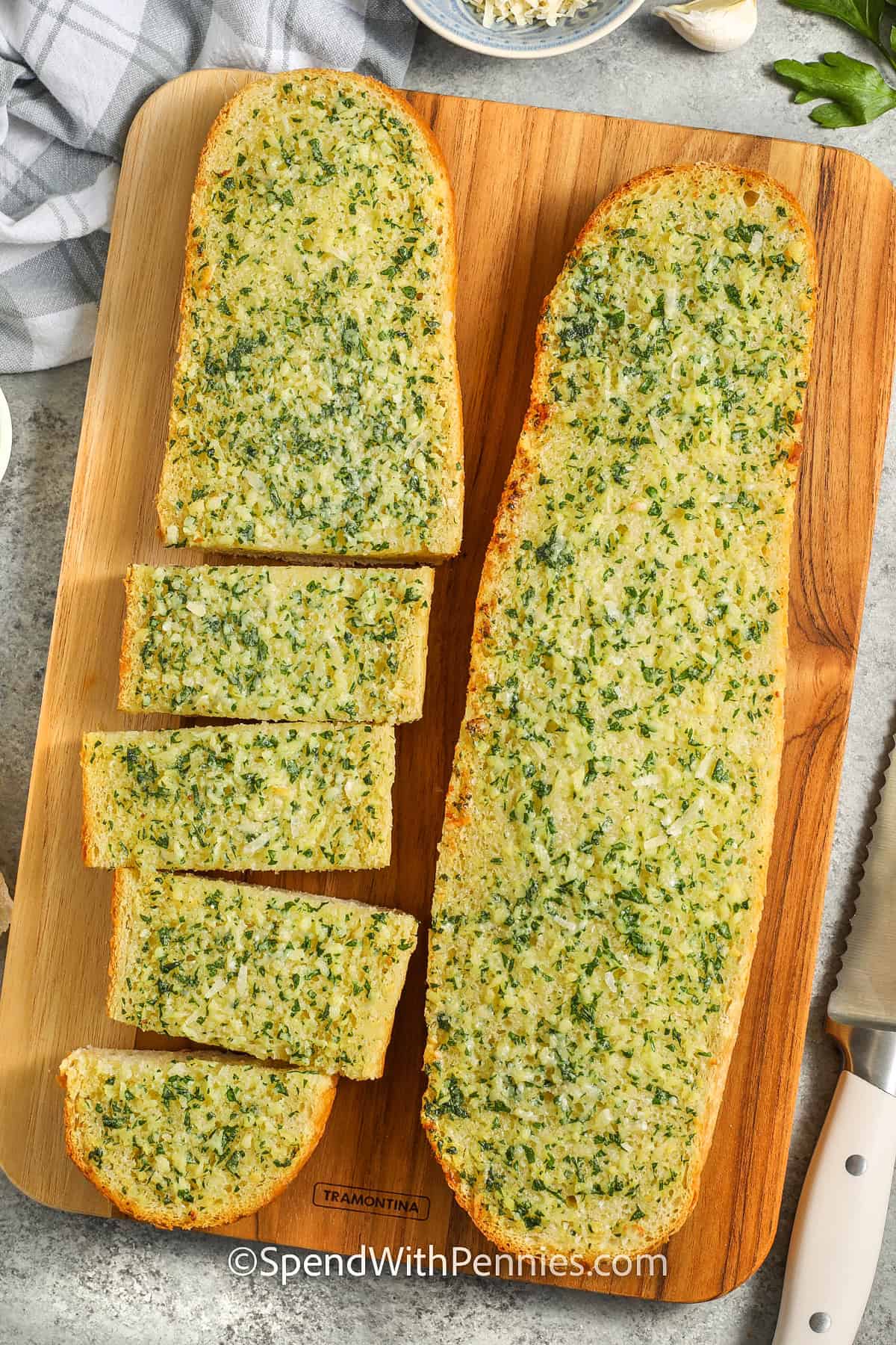 Homemade garlic bread with half cut into slices