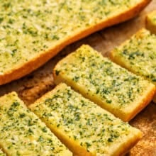 Homemade garlic bread cut into slices on a baking sheet