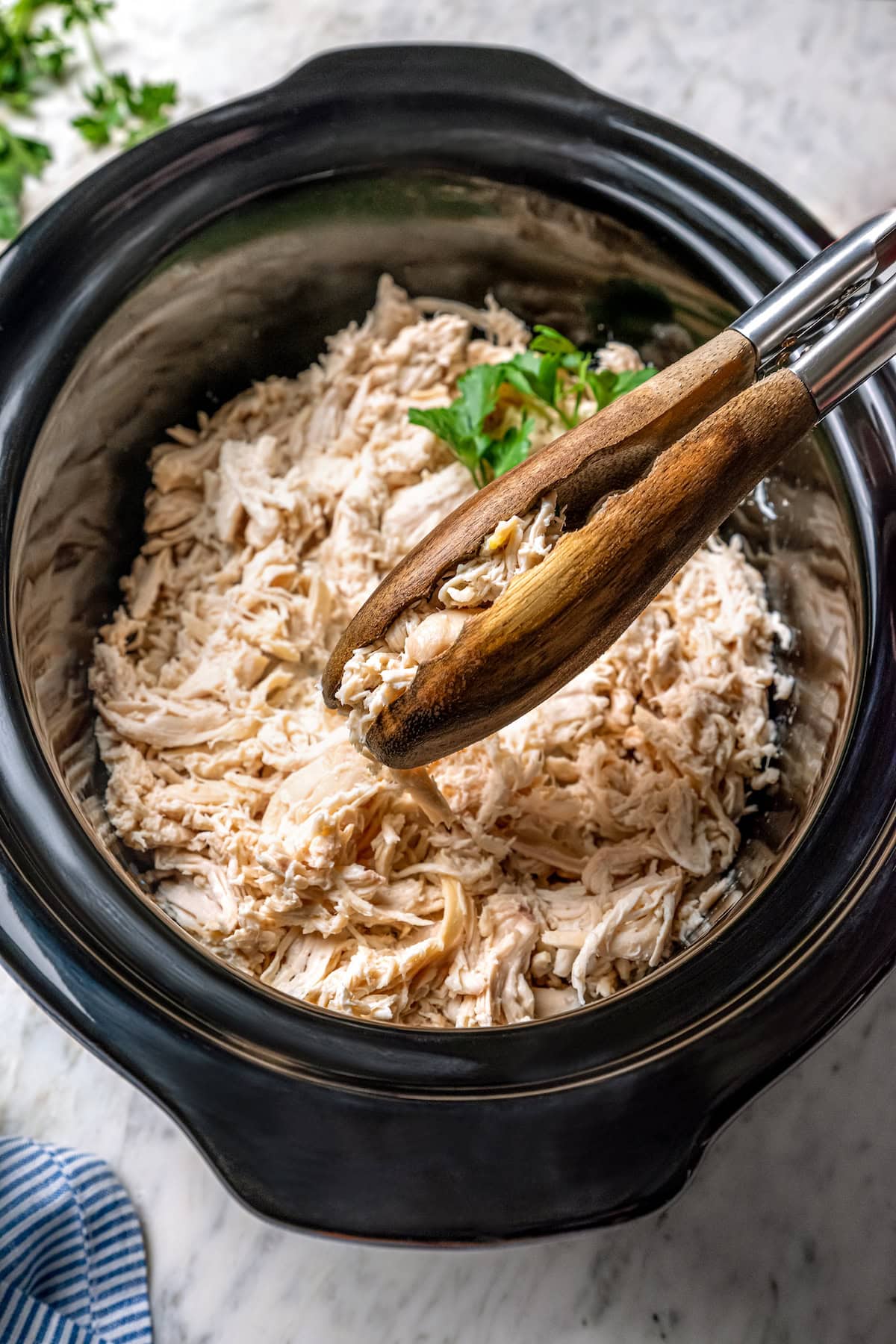 Tongs for grabbing shredded chicken from the slow cooker