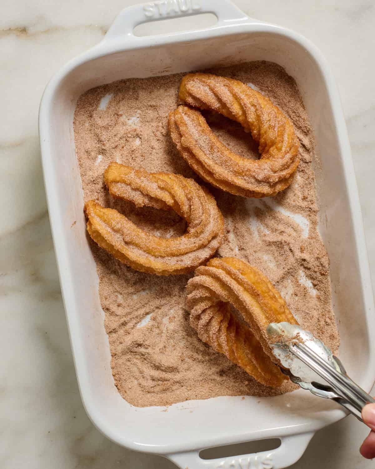 Churros dipped in sugar and cinnamon. 