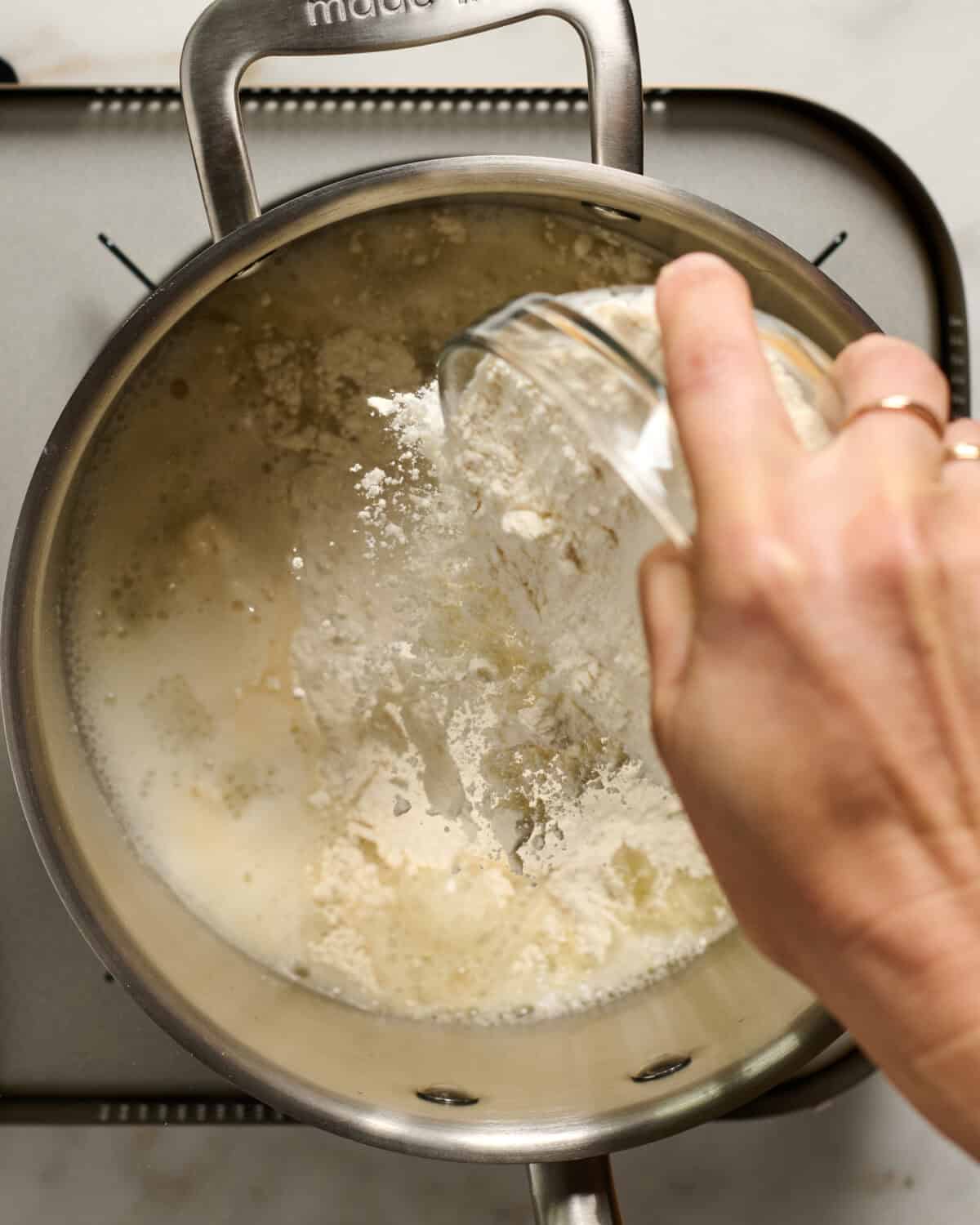 Flour is added to the pan. 