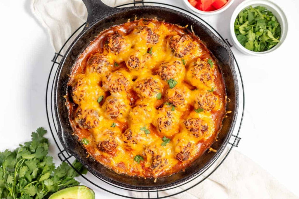 Mexican meatballs with cheese in a pan.