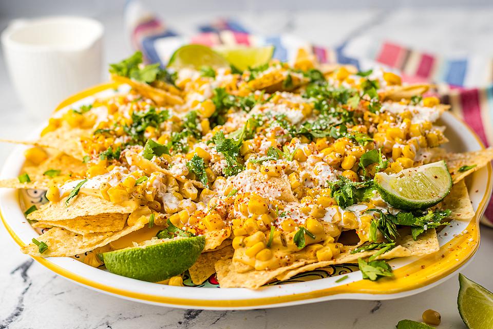 Street corn nachos stacked on a plate.