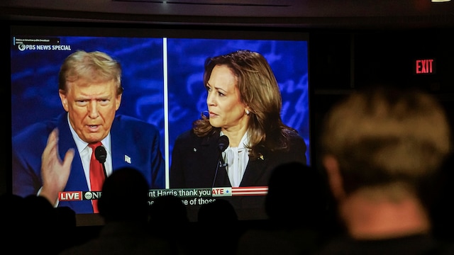 Dr. Christopher Terry's students watch the debate between former President Donald Trump, the Republican presidential candidate, and Vice President Kamala Harris, the Democratic presidential candidate, during an on-campus watch party at the University of Minnesota's Murphy Hall on Tuesday September 10, 2024, in Minneapolis. (Kerem Yücel/Minnesota Public Radio via AP)